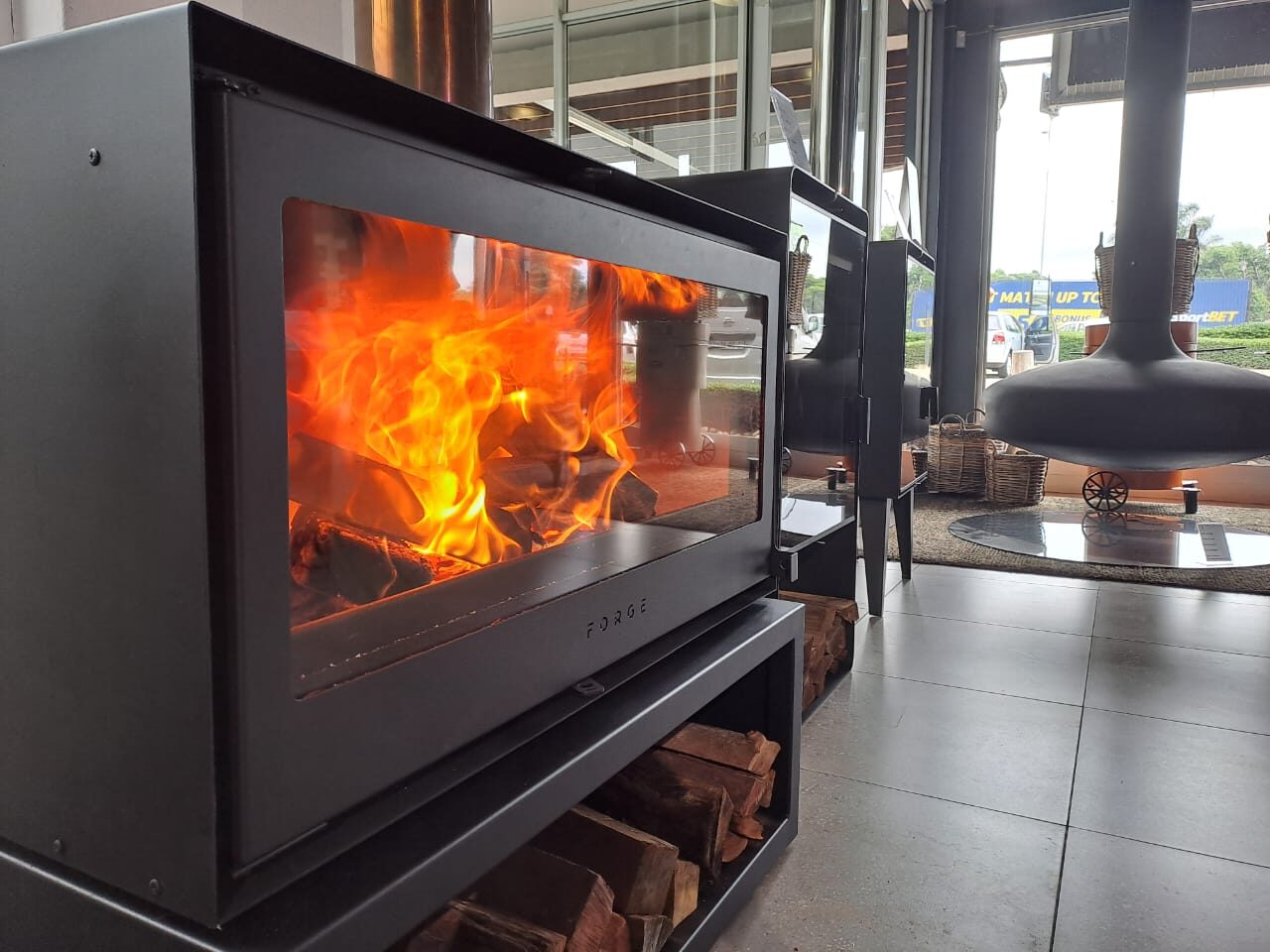 Forge freestanding wood fireplace on a log box