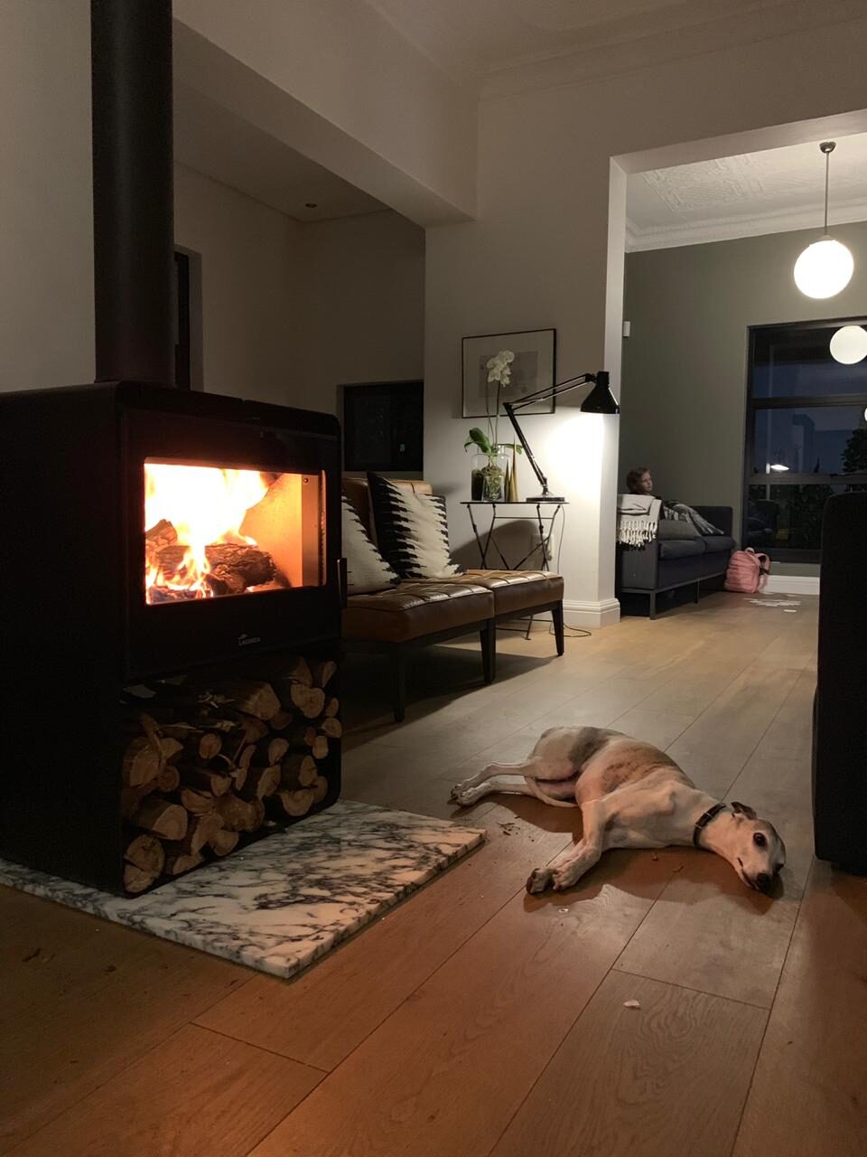 Lacunza Atlantic 603 cast-iron stove alight in a darkened living room